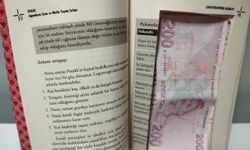 Samsun'da sahte parayı saklamak amacıyla kitabın içini para ölçüsünde kesen 2 zanlı yakalandı